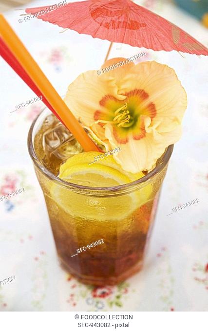 Cuba Libre with cocktail umbrella and amaryllis flower