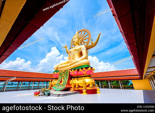 Large gold buddha statue in a sitting position under the blue sky at Big Buddha Temple is a famous tourist destination of Koh Samui island, Surat Thani province