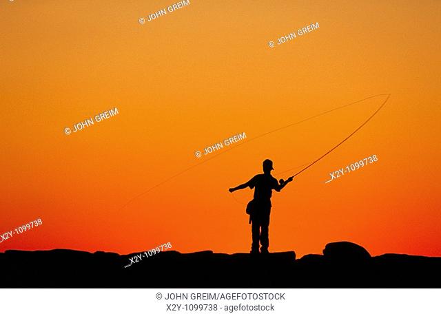 Boy fishing from a jetty at sunset, Menemsha, Martha's Vineyard