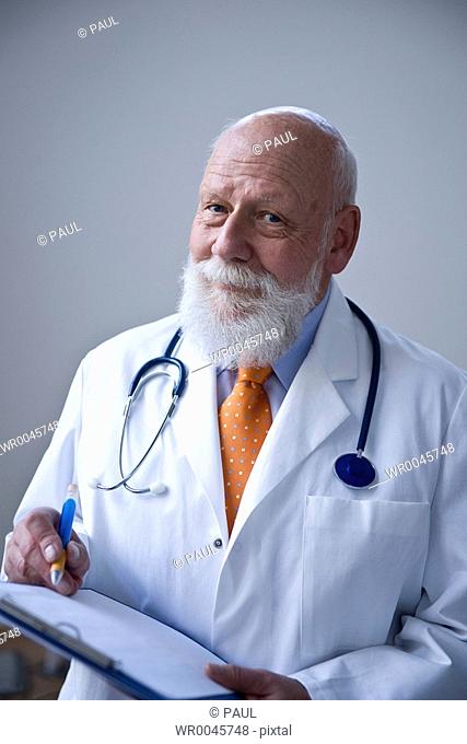Male doctor holding clipboard