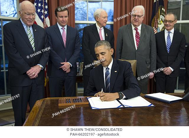 United States President Barack Obama signs H.R. 1428 - Judicial Redress Act of 2015 during a ceremony in the Oval Office of the White House in Washington, DC