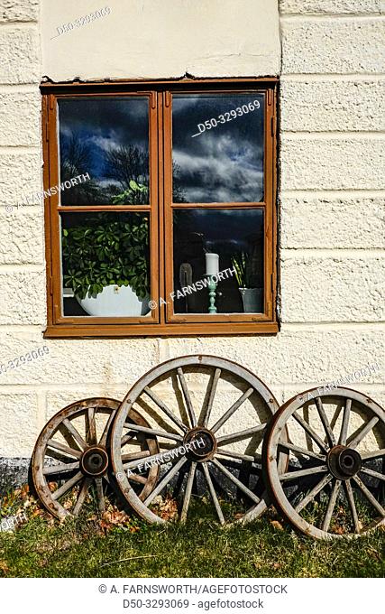 Stockholm, Sweden A window and old carriage wheels at Rosersbergs Slott or Rosersbergs Castle, a royal palace from 1634 in the Sigtuna municipality outside the...