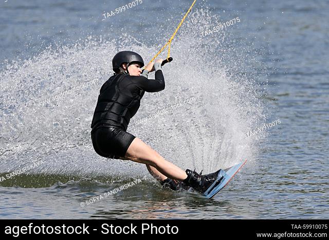 RUSSIA, MOSCOW - JUNE 18, 2023: A wakeboarder is seen on the Verkhny Putyayevsky Pond in Sokolniki Park. Sofya Sandurskaya/TASS
