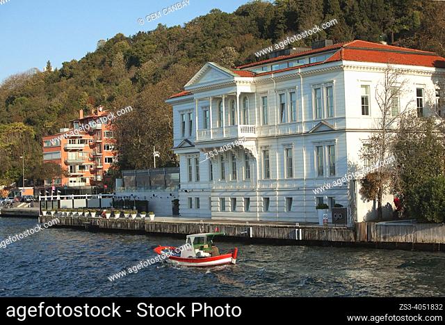 Fishing boat in front of the traditional seaside residence Ahmet Rasim Pasa Yalisi today used as Ajia Hotel in Cubuklu village