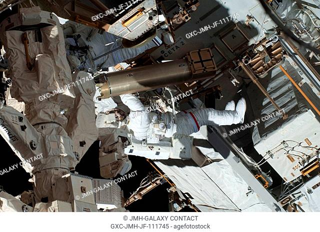 NASA astronauts Robert Behnken and Nicholas Patrick (partially obscured at top left), both STS-130 mission specialists, participate in the mission's first...