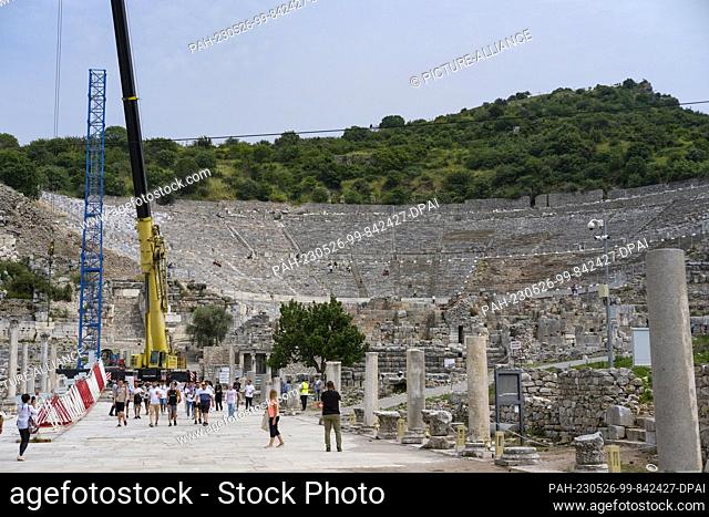 PRODUCTION - 11 May 2023, Turkey, Selcuk: Tourists visit the ancient city of Ephesus with the Great Theater, on which construction work is in progress