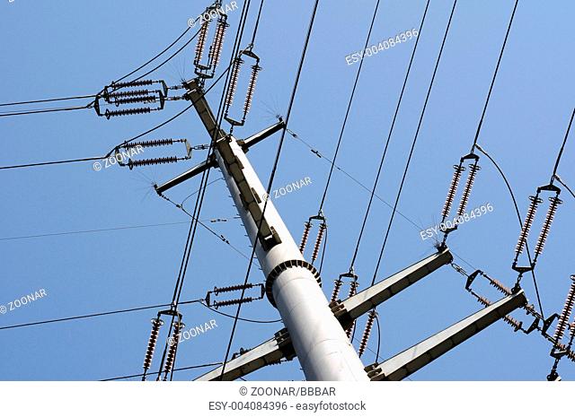 High voltage transmission lines against the blue sky