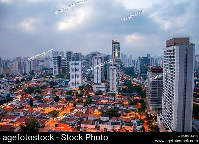 View of the city skyline in the early morning light with houses and buildings under cloudy skies in the city of Sao Paulo