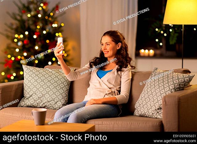 woman taking selfie at home on christmas