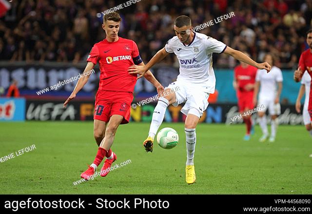 FCSB's Octavian Popescu and Anderlecht's Zeno Debast fight for the ball during a soccer game between Romanian Fotbal Club FCSB and Belgian RSC Anderlecht