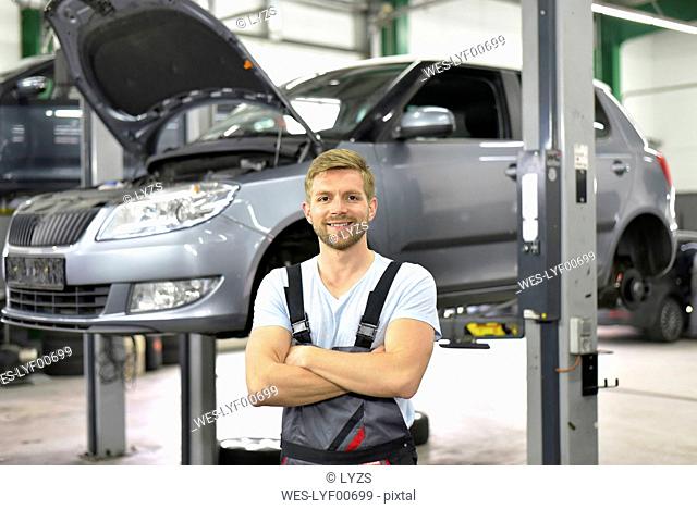 Portrait of smiling car mechanic in a workshop