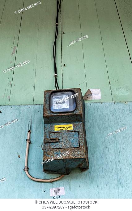 Wall with old electric meter in the Thjia's Family house, Singkawang, Wes Kalimantan, Indonesia