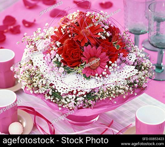 Romantic arrangement of roses, gerbera, gypsophila