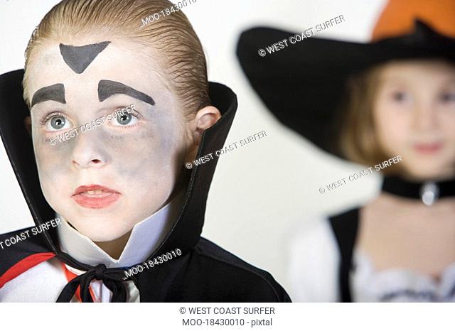 Boy 7-9 wearing dracula costume girl in background