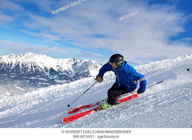 Young skier with sporty style of skiing at the descent from the Hohe Salve, Hopfgarten, Tyrol, Austria