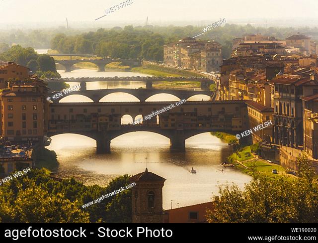 High view along the Arno river to the Ponte Vecchio, the old bridge. Florence, Tuscany, Italy. The historic centre of Florence is a UNESCO World Heritage Site