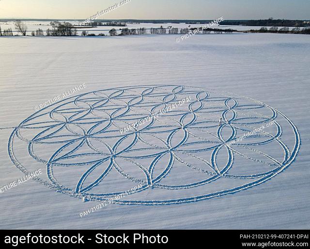 10 February 2021, Brandenburg, Jacobsdorf: The symbol ""Flower of Life"" can be seen as a huge pattern in the snow (aerial view with a drone)