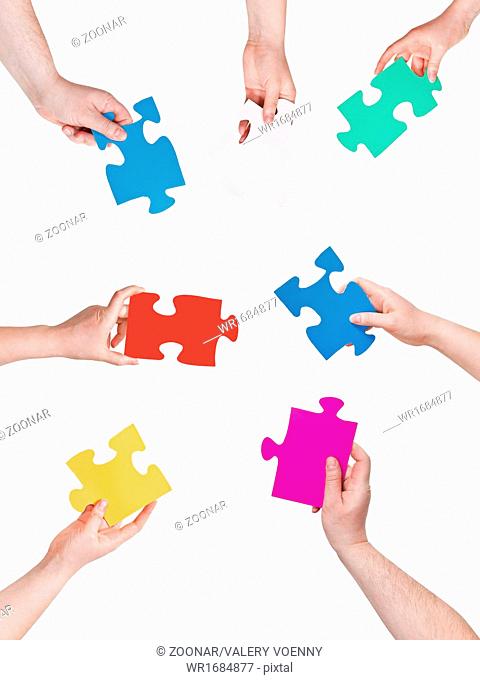 people hands circle with different puzzle pieces