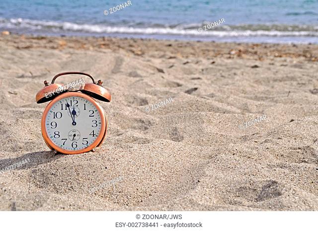 Alarm clock on beach