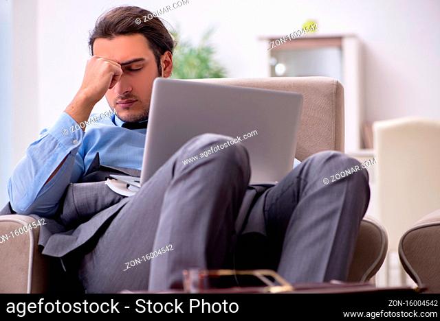Tired businessman employee working from the home