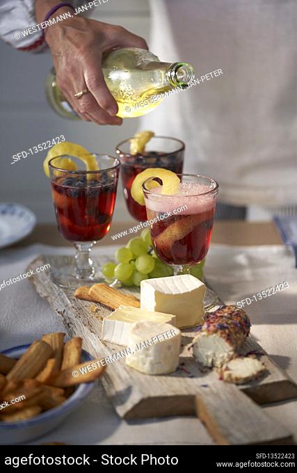 Cheese platter and blueberry-rum cocktail