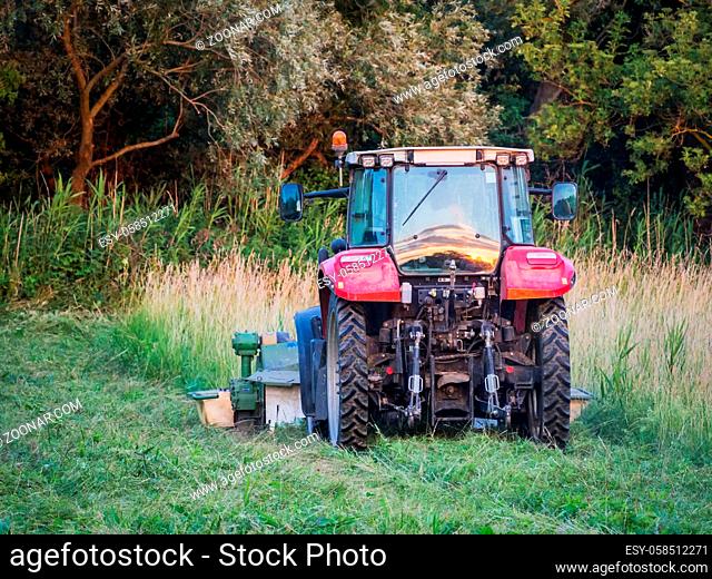Tractor mowing a meadow