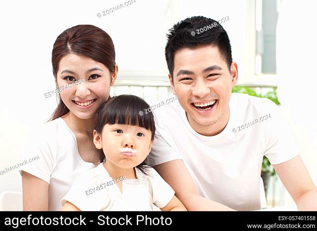 A happy family of three and milk high quality photo