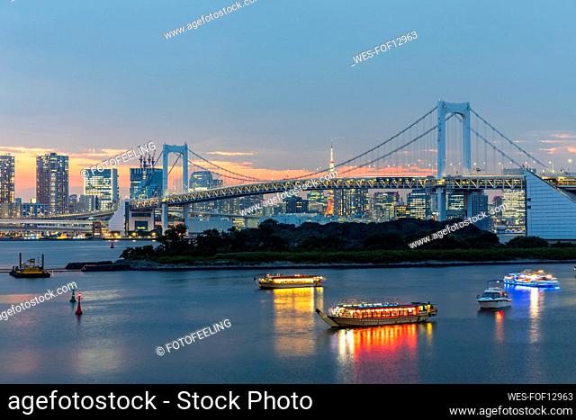 Japan, Kanto Region, Tokyo, Long exposure of Tokyo Bay and Rainbow Bridge at dusk