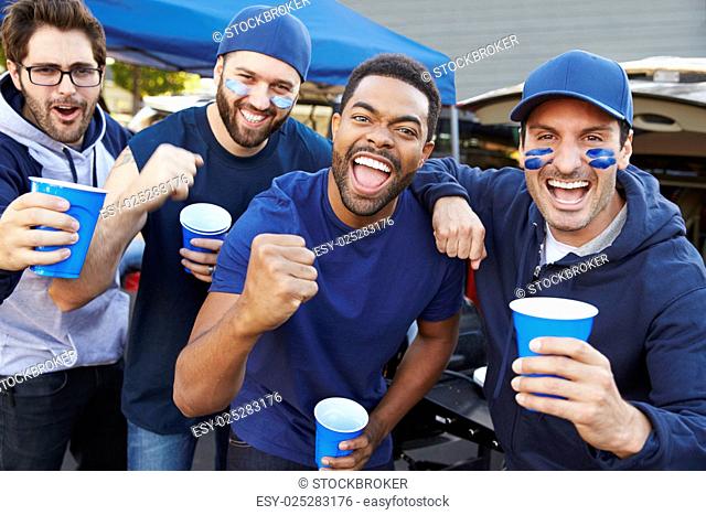 Group Of Male Sports Fans Tailgating In Stadium Car Park