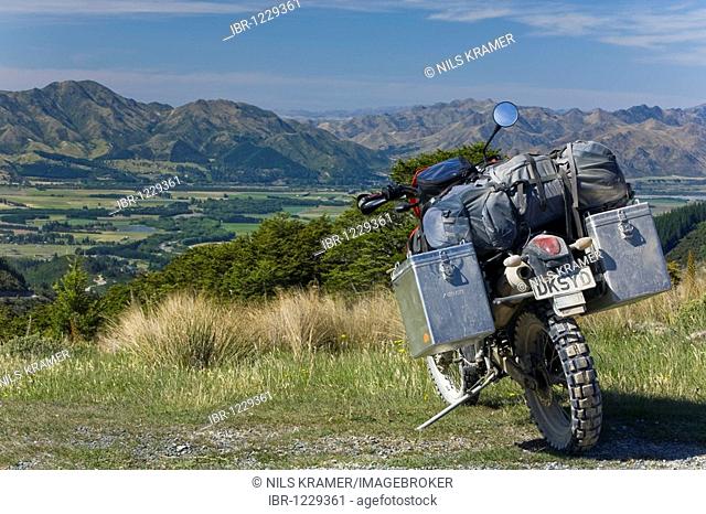 Heavily packed enduro motorcycle in front of Hanmner Springs Valley with views of Mount Saul, Rainbow Track, South Island, New Zealand