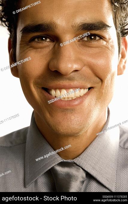 Close up of Hispanic businessman smiling
