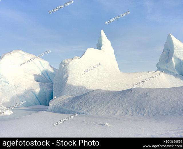 Iceberg frozen into the sea ice of the Melville Bay, part of the Baffin Bay, near Kullorsuaq in the far north of West Greenland