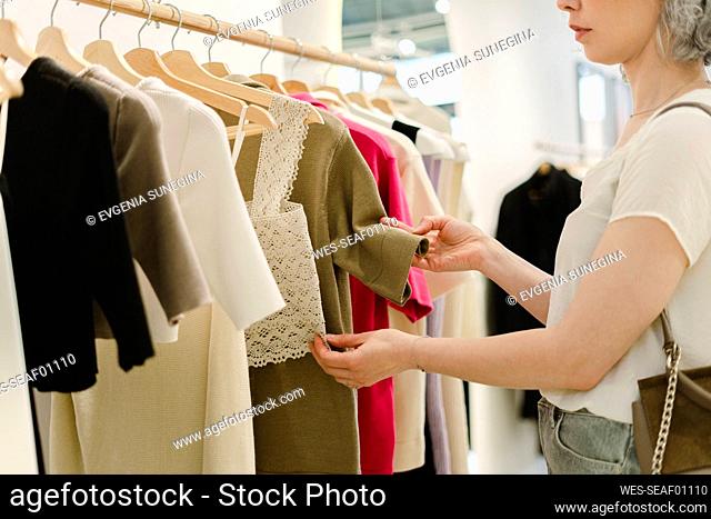 Woman shopping at clothes store