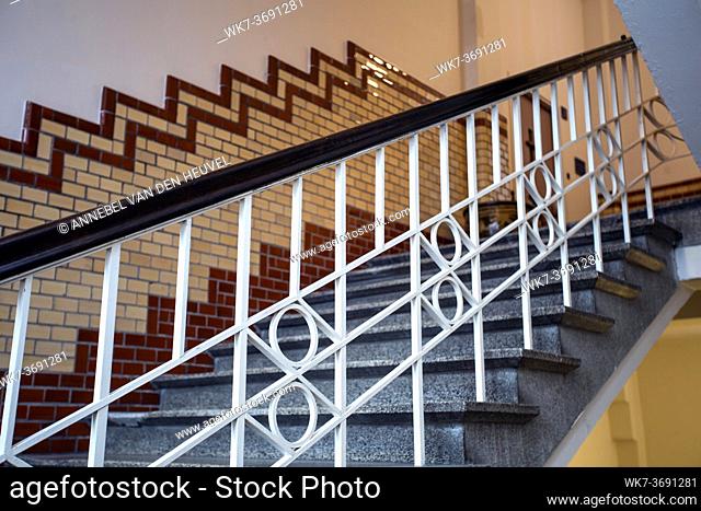 Old historic building with luxury stairs and tiled wall, beautiful marble design of old building Luxe and white handrail
