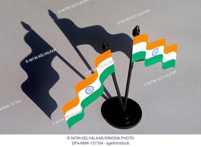 Aerial view with shadow of two flying Indian tricolour ; national flag with blue Ashoka Chakra hoisted to pole ; paper material ; Borivali ; Bombay Mumbai ;...