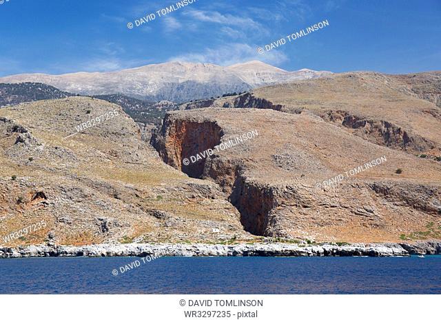 View from sea to the Aradena Gorge and distant peaks of the Lefka Ori, Loutro, Hania (Chania), Crete, Greek Islands, Greece, Europe