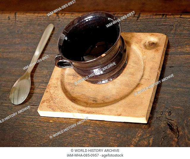 Elizabethan wooden plate with glazed pottery cup. From Blakesley Hall is a Tudor hall on Blakesley Road, Yardley, Birmingham, England
