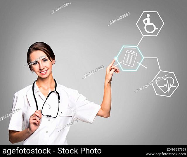 Young female doctor in uniform touch hexagon with icons over gray background