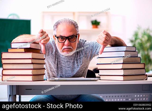 Senior male student being exhausted during exam preparation
