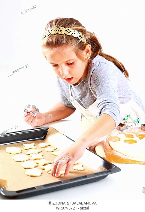 Cute girl baking cookies