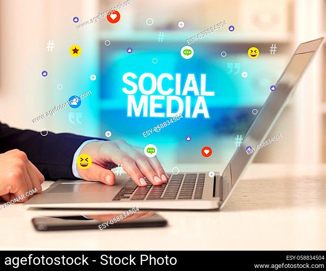 Freelance woman using laptop with SOCIAL MEDIA inscription, Social media concept