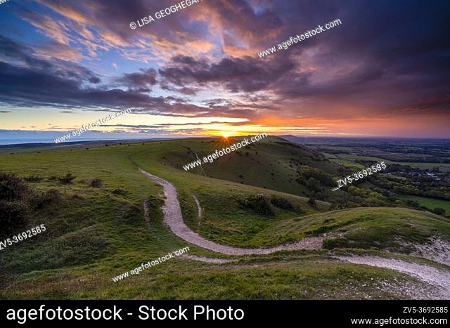 Sunset over Fulking village and views towards truleigh hiill and the sea on the South Downs National Park from Devil's Dyke, Sussex, England