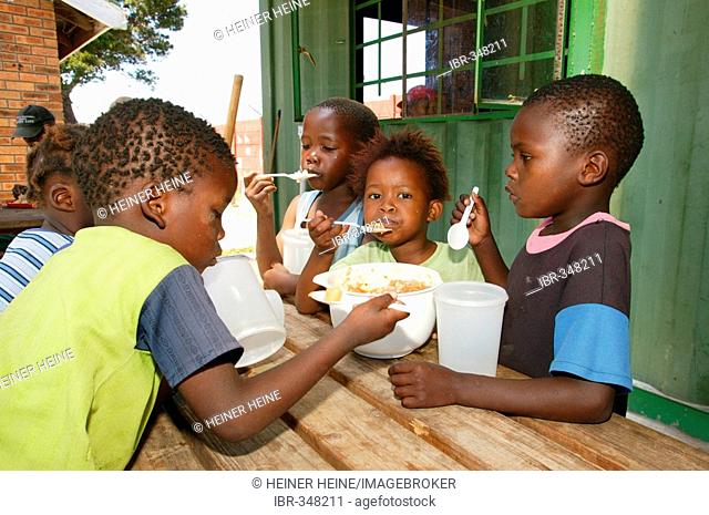 Children eating in a soup kitchen, Cape Town, South Africa