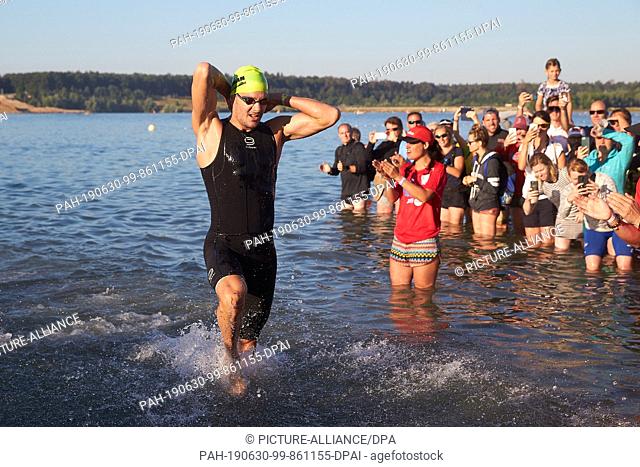 30 June 2019, Hessen, Frankfurt/Main: German Jan Frodeno is the first to leave the water at the Ironman European Triathlon Championships with swimming over 3