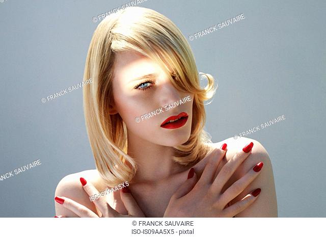Young woman with red fingernails, portrait