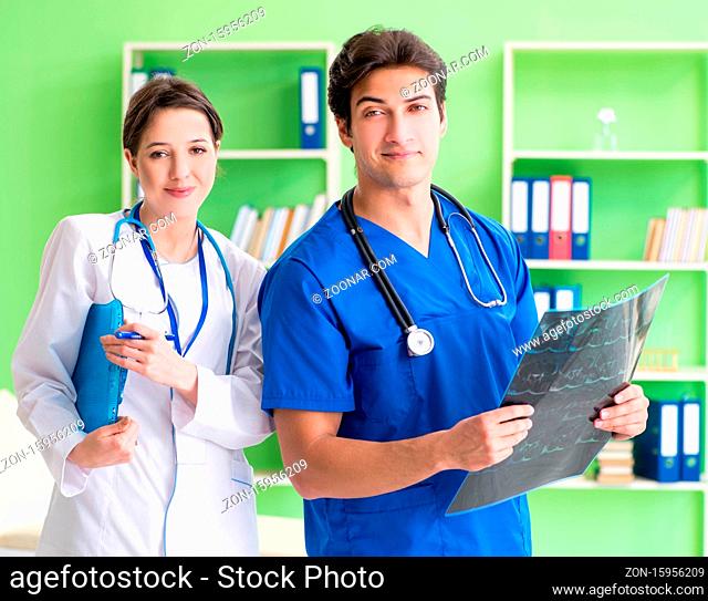 Woman and man gynecologists discussing medical case at the clinic