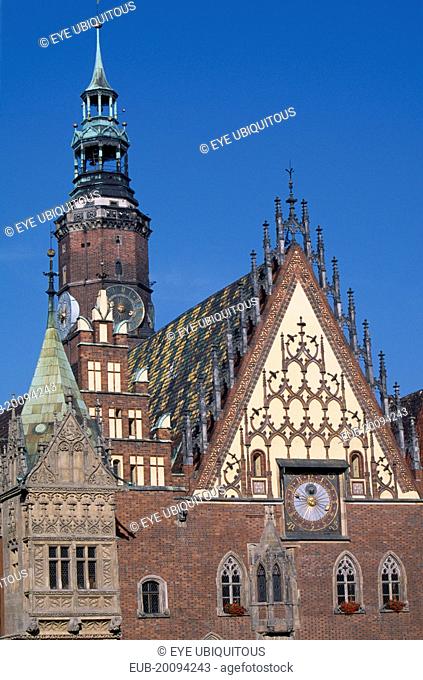 Wroclaw Town Hall dating from the fourteenth century. Part view of exterior with decorative gable and brickwork astronomical clock and clock tower
