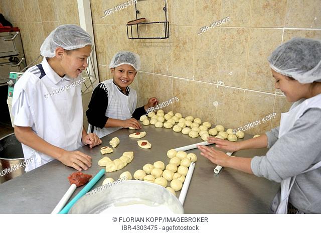 Children, boys working in bakery, vocational training, Creciendo Unidos social project, Villa Javier, Bogotá, Colombia