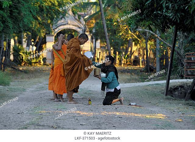 Buddhist monks collecting alms in the early morning at Muang Khong, Si Pan Don, Four Thousend Islands, Laos