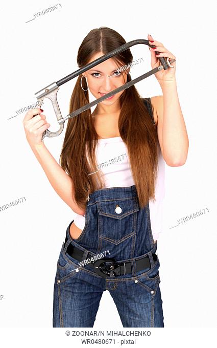 Attractive young woman in overalls holding handsaw